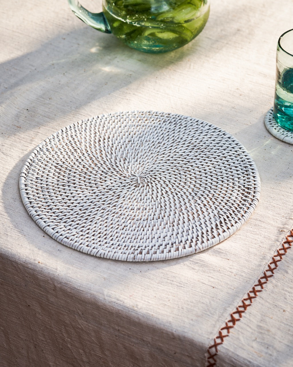Latha round rattan placemats in white, side view