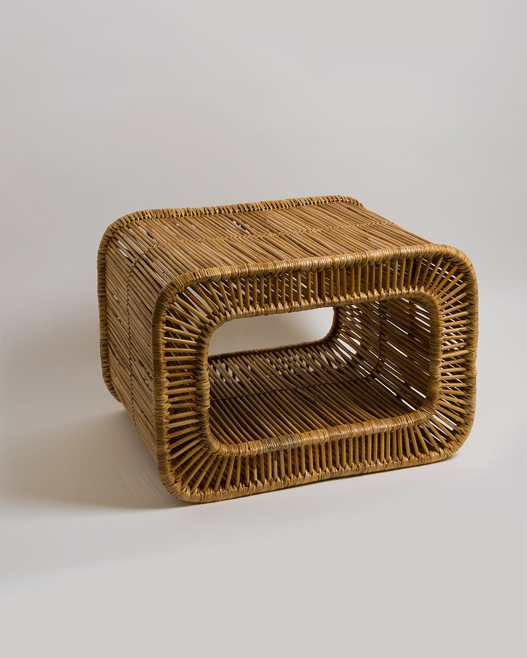 Patti curved rattan side table, side view