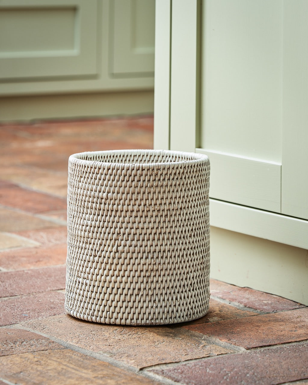 Rangoon rattan waste paper basket in white, side view
